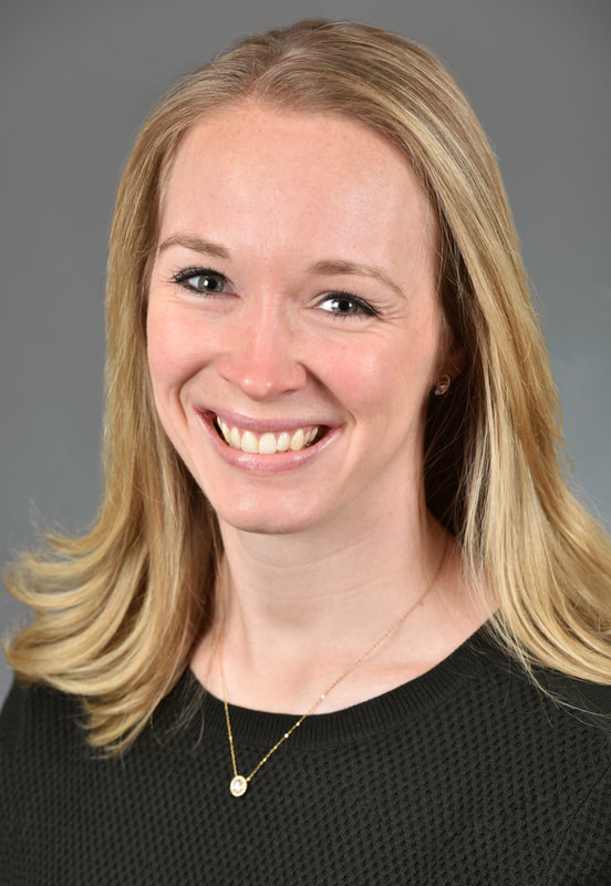Headshot of woman Shoulder length blonde hair, wears black Smiles at camera